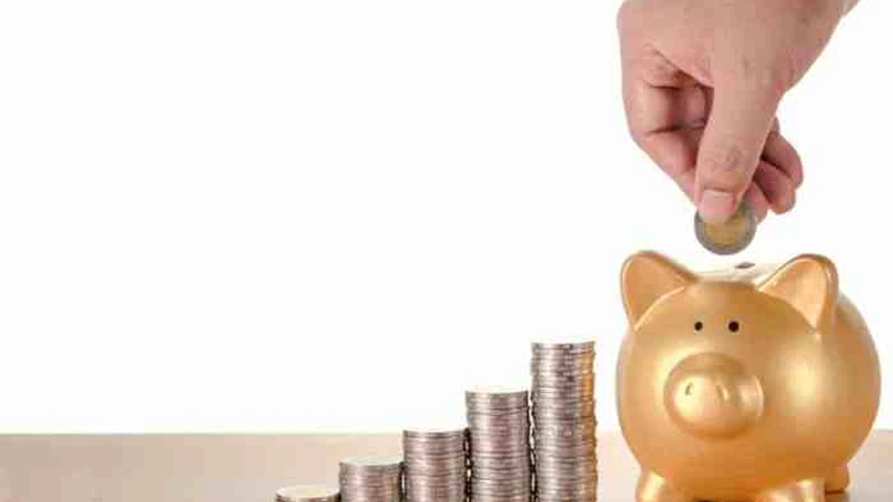 Close up on a plate of mashed potatoes, topped with baked pork chops with cream of mushroom soup, and a side of green beans.