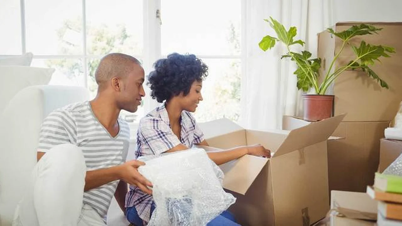 blue bowl of black bean beef tortilla soup on a board with cilantro and shredded cheese in background