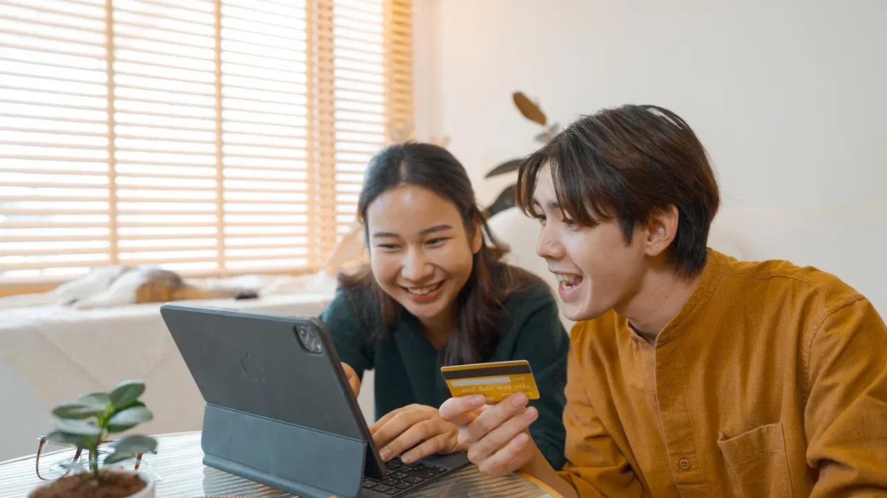 Close up on a plate of mashed potatoes, topped with baked pork chops with cream of mushroom soup, and a side of green beans.